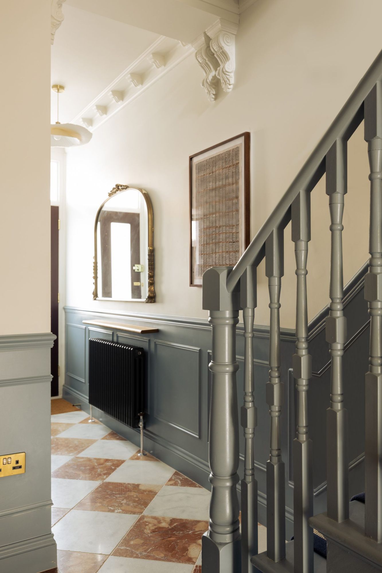 Hallway with panelling and painted staircase