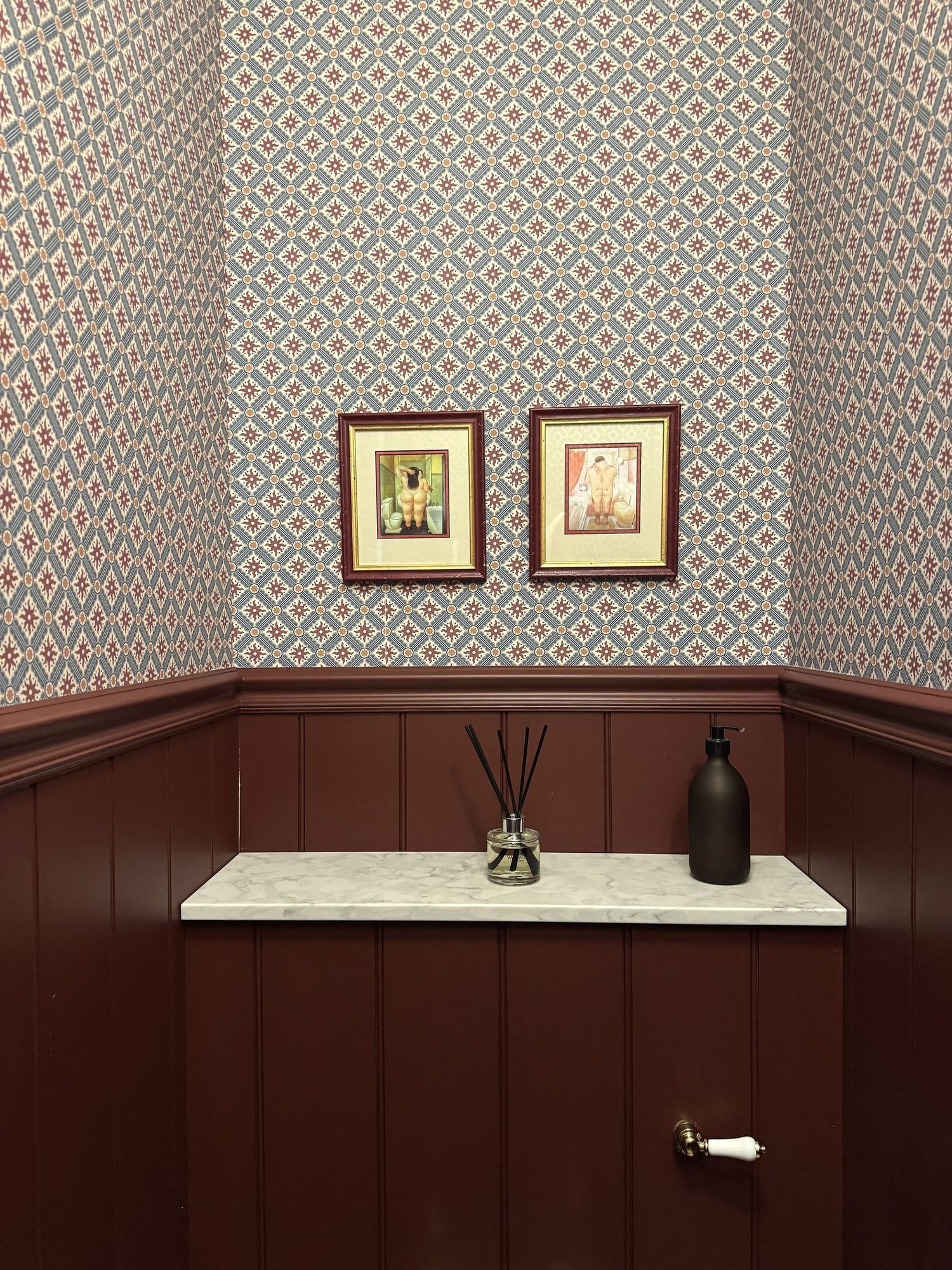 Cloakroom shelf with framed prints
