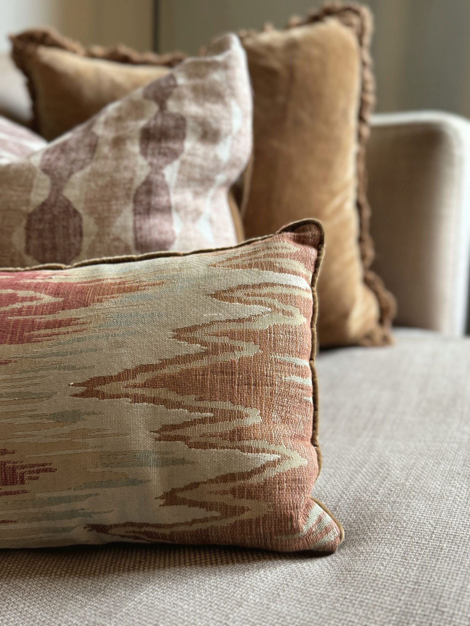 Layered ikat and velvet cushions